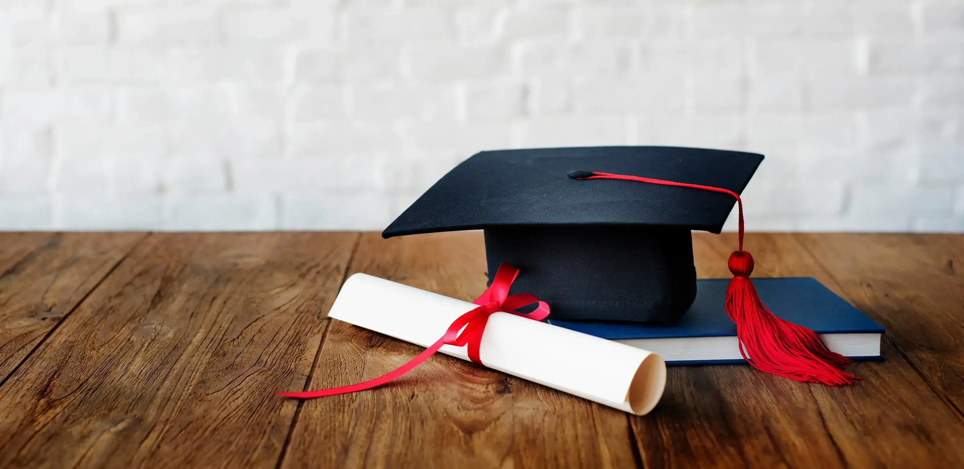 Graduation cap and diploma symbolizing college, undergraduate, and MBA admissions success